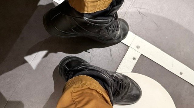 Authors black Nike AF1 mid shoes.